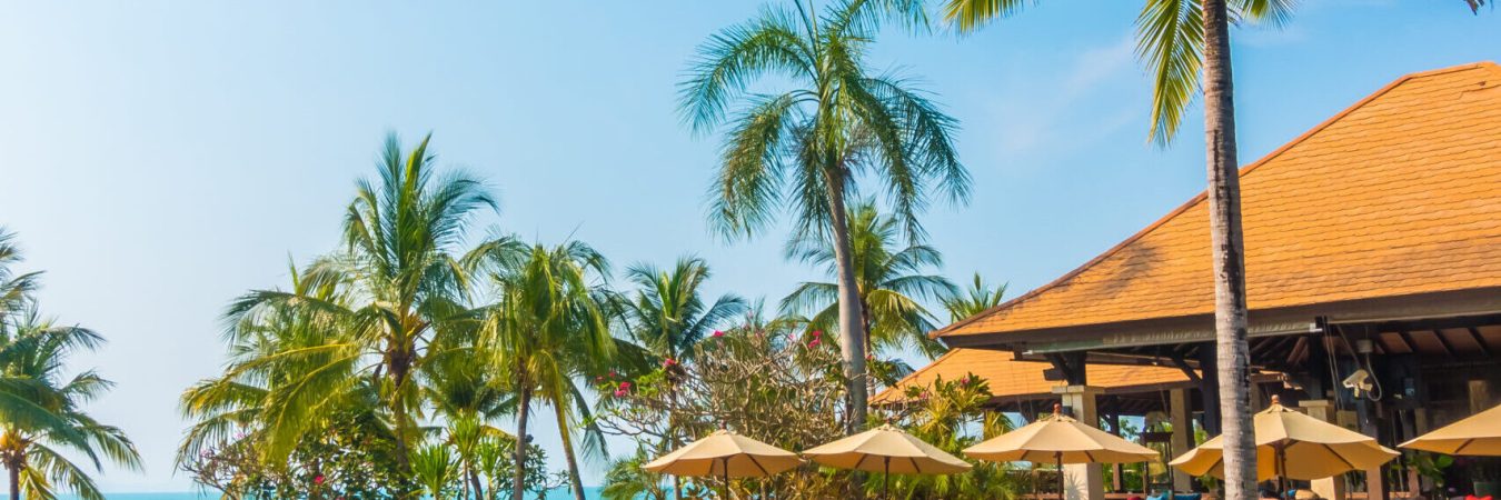 Beautiful luxury Swimming pool with palm tree and sea background in hotel pool resort - Boost up color Processing